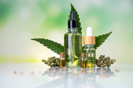 Photo for Hemp oil in bottle with hemp oil and fresh cannabis on a white wooden background with hemp leaves - Royalty Free Image
