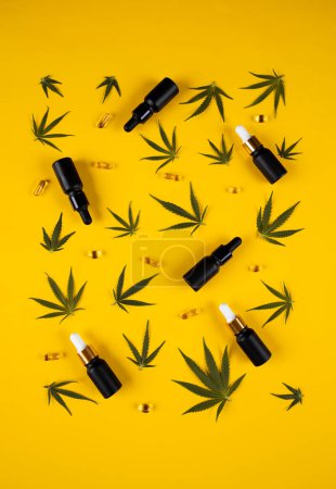 Photo for Flat lay composition with black bottles of oil and marijuana on white background with copy space. - Royalty Free Image