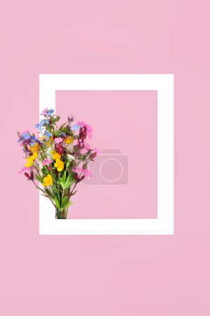 Foto de Spring wildflower posy, white frame on pink background. Minimal abstract border nature composition for Valentines Day, Mothers Day, Easter, birthday. British flora. Flat lay. - Imagen libre de derechos