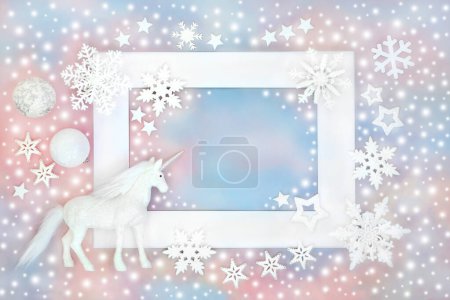 Photo for Christmas unicorn, snowflakes and white bauble decorations on blue pink sky background white frame. Festive design for greeting card, gift tag, label, invitation - Royalty Free Image