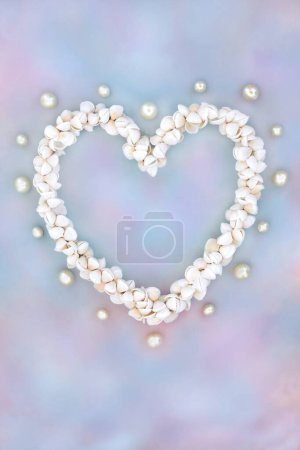 Photo for Heart shaped cockleshell wreath with oyster pearls on rainbow sky cloud background. Symbol of nature sea life summer love. Greetings card for Valentines, birthday, mothers day or anniversary. - Royalty Free Image