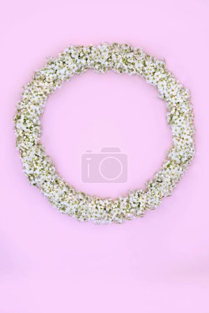 Hawthorn blossom flower wreath on pink background. Floral feminine spring garland for logo, menu, invitation, card for Mothers Day, Beltane, anniversary, birthday, wedding day. 