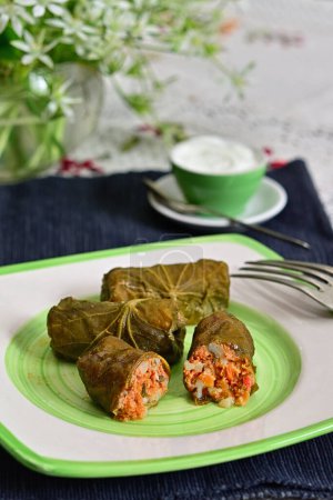Photo for Dolma Rolls Stuffed With Meat, Rice And Vegetables Rolled in Lindens Leaves With Cream - Royalty Free Image