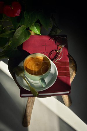 Photo for Vintage Morning Coffee Cup On Bible and Sun Rays - Royalty Free Image