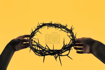 Concept Hands holding crown of thorns 