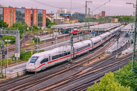 Photo for 26 July 2022, Munster, Germany: modern high speed intercity DB Deutche Bahn train carries passengers. Branching of railway rails near stations and platforms - Royalty Free Image