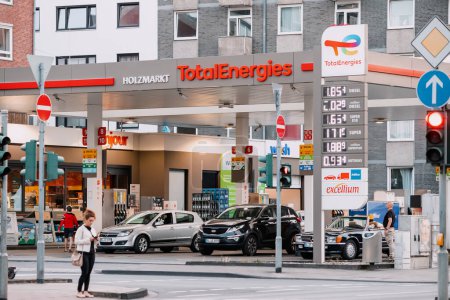 Photo for 30 July 2022, Cologne, Germany: Motorists fill their cars with gasoline and diesel at the Total energies gas station. Inflation and expensive prices for petroleum products - Royalty Free Image