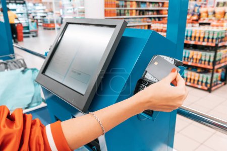 supermarkets automated self-service checkout system provides a seamless shopping experience, allowing customers to scan and pay with credit card for their items at their own pace.
