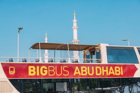 Photo for 15 January 2023, Abu Dhabi, UAE: Bigbus - popular tourist sightseeing transport and Sheikh Zayed Grand Mosque in the background - Royalty Free Image