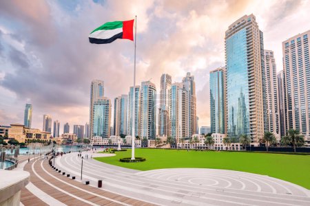 Scenic view of Dubai skyline, with the skyscraper buildings and national flag. Sightseeing and travel destinations in Arab Emirates