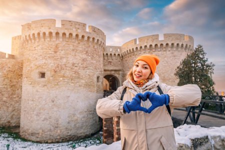 Happy tourist girl at the Zindan gate entrance to Kalemegdan fortress. Travel attractions and destinations in Belgrade
