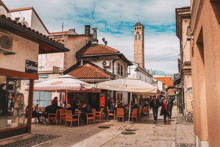 Photo for 15 March 2024, Sarajevo, Bosnia and Herzegovina: Iconic Sahat Tower rises majestically amidst Sarajevo's historic bazaar, a must-see attraction blending Ottoman charm with European allure. - Royalty Free Image