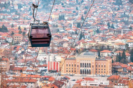 the beauty of Sarajevo's skyline from above as you journey through the cityscape in a cable car, passing over the rooftops and town hall.