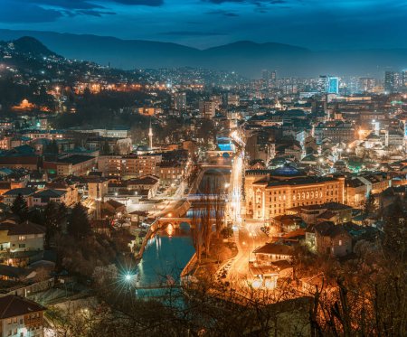 The picturesque cityscape of Sarajevo bathed in the soft glow of twilight invites travelers to explore its historic landmarks and immerse themselves in its captivating atmosphere.