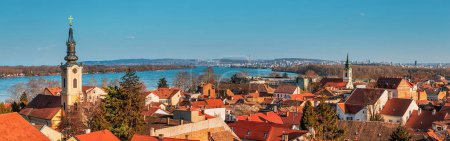 Explore Belgrade's scenic skyline with its iconic red rooftops and historic landmarks, including the belfry and cathedral, offering a picturesque view of the cityscape.