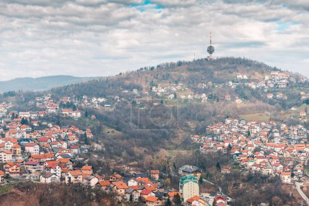 Sarajevo's captivating cityscape from above, with its historic rooftops nestled between the mountains of Bosnia and Herzegovina, and the iconic TV tower rising tall against the skyline.