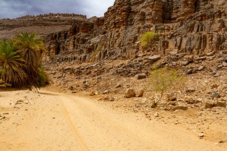 Photo for Oued Aharhar Gorge. Dirt road among the rocks. Tadrart mountains. Aharghar Canyon, Tadrart mountains, Tassili n'Ajjer National Park, Illizi Province, Djanet, Algeria, Africa - Royalty Free Image