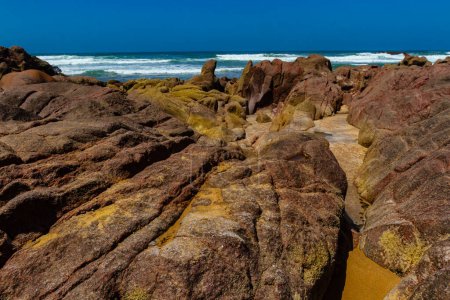Photo for Picturesque coastal red rocks on the Atlantic Ocean coast.Legzira beach ( ore Gzira).  Morocco, Africa. - Royalty Free Image