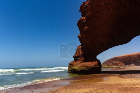 Photo for Spectacular natural red arch on atlantic ocean coast, Legzira ( or Lagzira, or Gzira) beach. Sidi Ifni, Morocco, Africa - Royalty Free Image