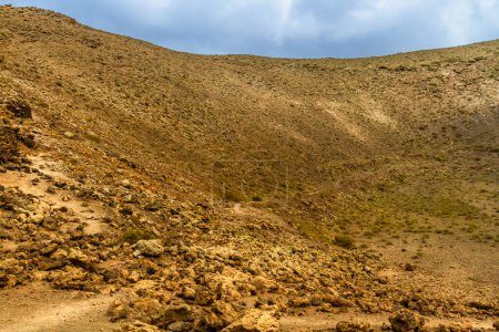 Photo for Hiking trail to Caldera Blanca. Interior the La Calderata ( Montana Calderata ) volcano. Los Volcanes Natural Park, Lanzarote, Canary Islands, Spain - Royalty Free Image