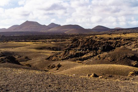 Photo for Trail around Cuervo volcano. "Malpais" -  barren and stony  field of lava. Cuervo volcano. Lanzarote, Canary Islands, Spain - Royalty Free Image