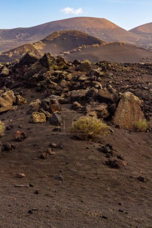 Trail around Cuervo volcano. "Malpais" -  barren and stony  field of lava. Cuervo volcano. Lanzarote, Canary Islands, Spain