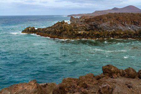 Cliffs of the steep volcanic coast of Los Hervideros. Lanzarote, Canary Islands, Spain