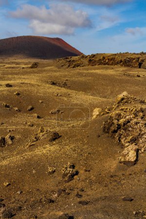 Haking trail around Montana Colorada. "Malpais" -  barren and stony  field of lava Colorada volcano. Lanzarote, Canary Islands, Spain