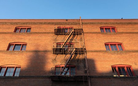 Portland, OR, USA - Oct 16, 2022: View of the apartment building with a fire escape staircase. Fire escapes on the facades of houses in Portland. Streets and architecture of Portland. 
