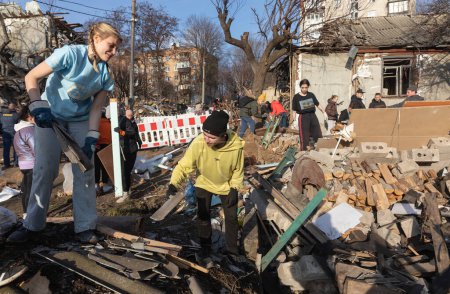 Photo for KYIV, UKRAINE - Jan. 03, 2023: War in Ukraine. Volunteers clear and dismantle debris at the site of a Russian missile attack on December 31 - Royalty Free Image