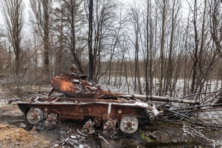 Foto de A tank of Russian invaders destroyed as a result of fierce and heavy fighting near a village Kuhari in the Kyiv region - Imagen libre de derechos