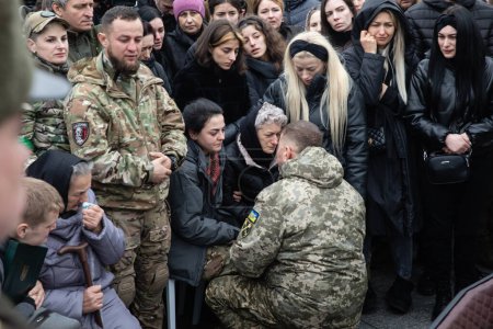 Photo for KYIV, UKRAINE - Mar. 10, 2023: General of the Armed Forces of Ukraine Valerii Zaluzhnyi says farewell words at the coffin containing body of the Hero of Ukraine Dmytro Kotsiubailo, known as Da Vinci - Royalty Free Image