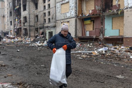 Téléchargez les photos : KYIV, UKRAINE - 05 janvier 2024 : Des volontaires et des résidents nettoient les débris et montent à bord des fenêtres du bloc résidentiel touché par un missile russe à Kiev, en Ukraine - en image libre de droit