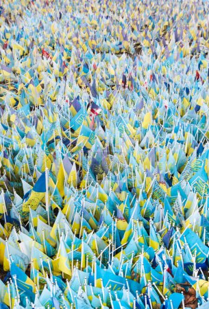 KYIV, UKRAINE - Feb. 18, 2024: A large number of Ukrainian flags on the central square of the capital with the names of prisoners and those who died in the war with Russia. Stickers 703017670