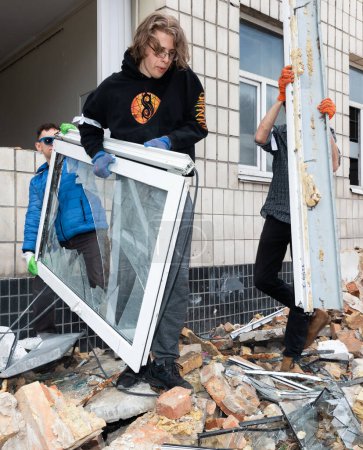 Photo for KYIV, UKRAINE - Mar. 30, 2024: Students and volunteers remove debris at Kyiv State Academy of Decorative Applied Arts and Design after it was damaged in a Russian missile strike - Royalty Free Image