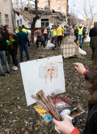 Photo for KYIV, UKRAINE - Mar. 30, 2024: Students of the art academy are making artistic sketches during the removal of the rubble of the destroyed academy building. - Royalty Free Image