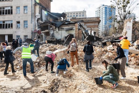 Photo for KYIV, UKRAINE - Mar. 30, 2024: Students and volunteers remove debris at Kyiv State Academy of Decorative Applied Arts and Design after it was damaged in a Russian missile strike - Royalty Free Image