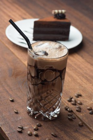 Photo for Glass Of Cold Coffee On Wood - Royalty Free Image