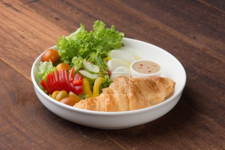 Photo for Croissant and salad on table - Royalty Free Image
