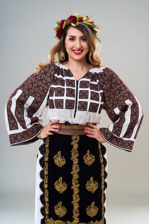 Photo for Young woman in popular vintage traditional Romanian costume, isolated on gray background - Royalty Free Image