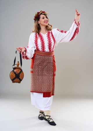 Photo for Young woman in popular vintage traditional Romanian costume, isolated on gray background - Royalty Free Image