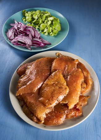 Foto de Lean skinless boneless chicken breast fillets seasoned and marinated ready for grill - Imagen libre de derechos