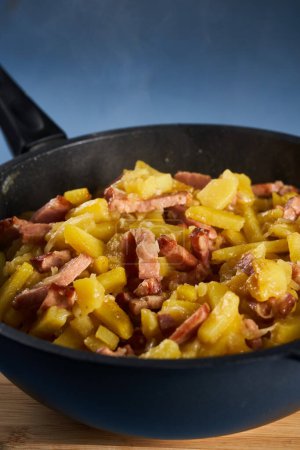 Photo for Potatoes and ham in a wok, freshly cooked - Royalty Free Image