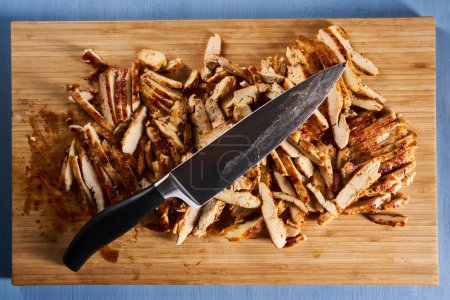 Photo for Roasted sliced chicken breast on a wooden board, ready to prepare fajitas - Royalty Free Image