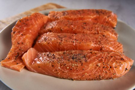 Photo for Seasoned salmon steak fillets on a plate in closeup - Royalty Free Image