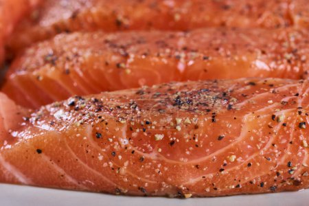 Photo for Seasoned salmon steak fillets on a plate in closeup - Royalty Free Image