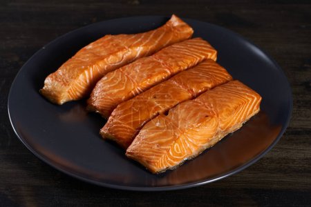 Photo for Smoked salmon steaks in closeup on wooden board - Royalty Free Image