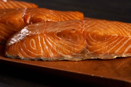 Téléchargez les photos : Smoked salmon steaks in closeup on wooden board - en image libre de droit