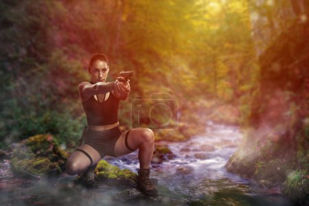 Foto de Adventurer young woman taking aim with her gun in a misty canyon crossing a river - Imagen libre de derechos
