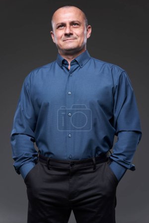 Photo for Confident businessman with hands in his pockets on gray background - Royalty Free Image